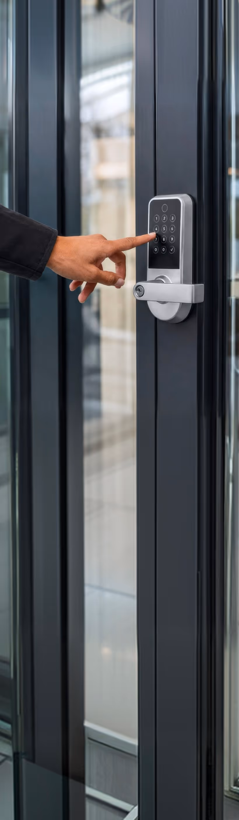 Hand entering code on a commercial keypad door lock
