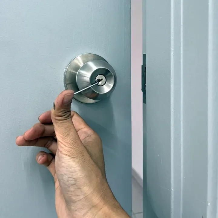 Locksmith unlocking a residential deadbolt during an emergency lockout